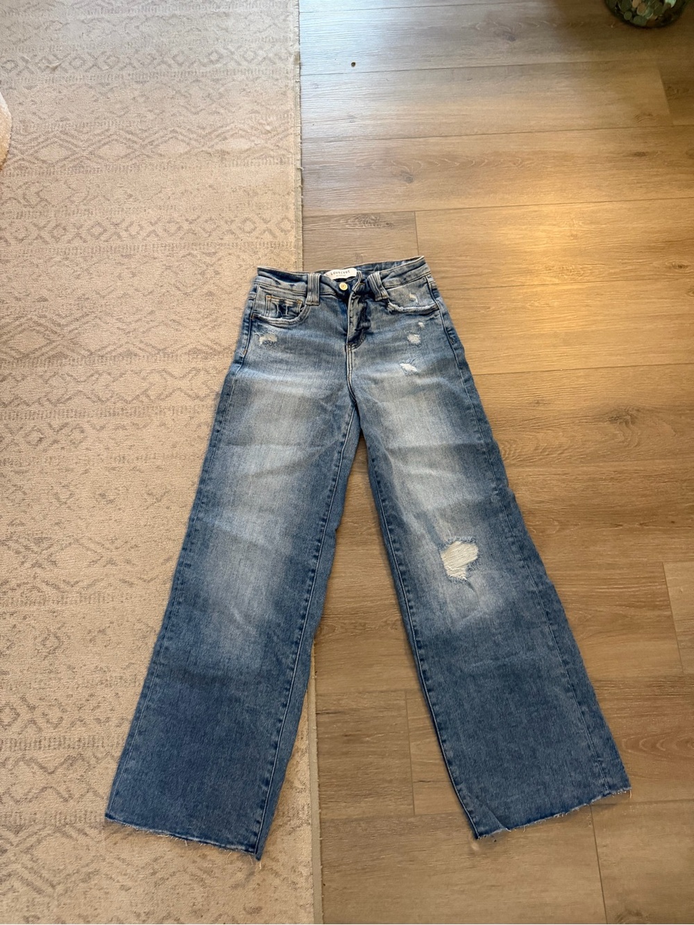 High-Rise Wide-Leg Distressed Jeans in Faded Blue